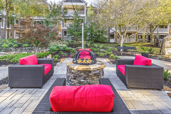 a seating area with a fire pit in the middle of a brick patio at Elan at Mallard Creek Apartment Homes, Charlotte